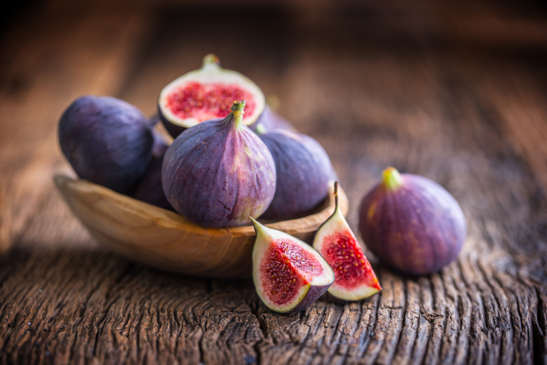 Close-up of figs on wooden table