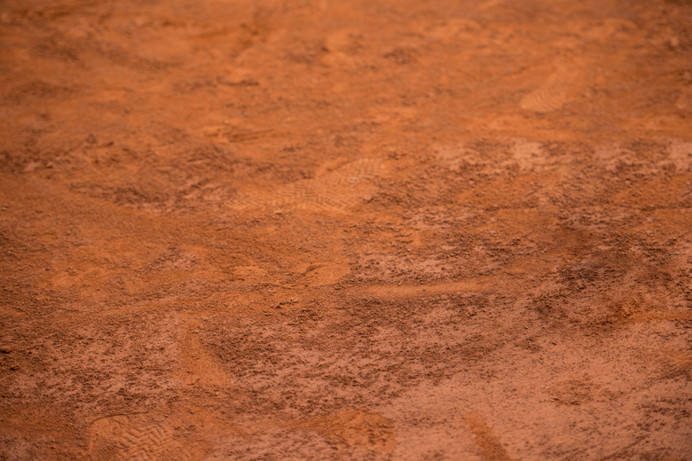 An orange-brown tennis clay court background.