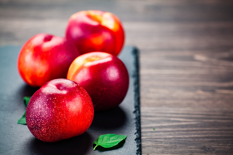 Peaches on black stone plate