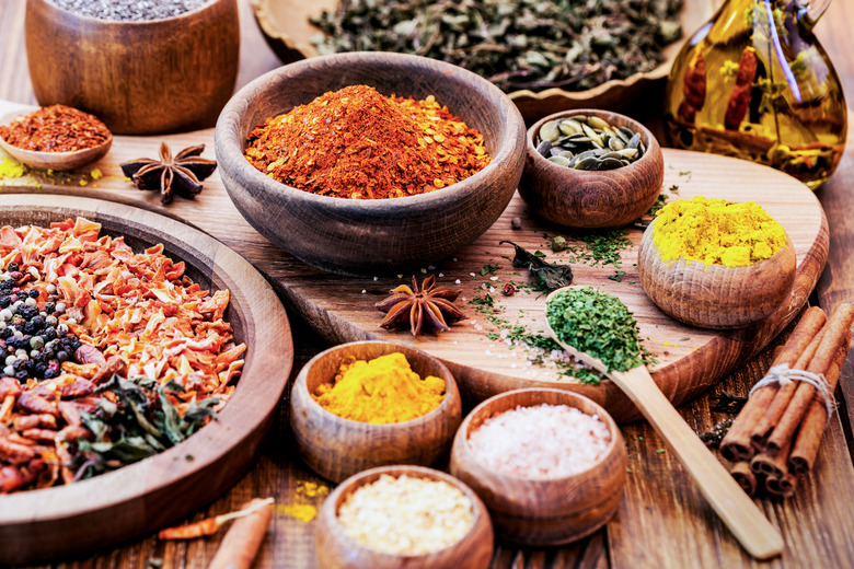 Spices and Herbs on Wooden Background