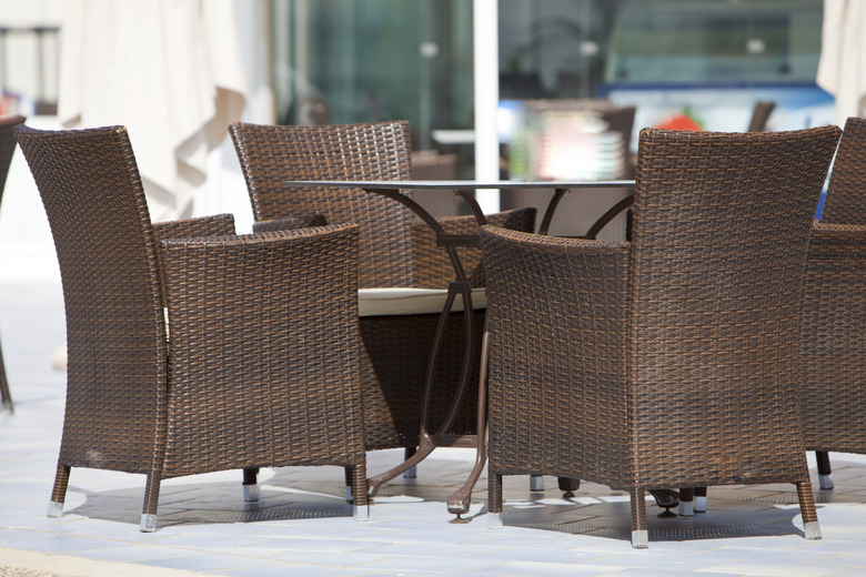 Empty wicker chairs around a table