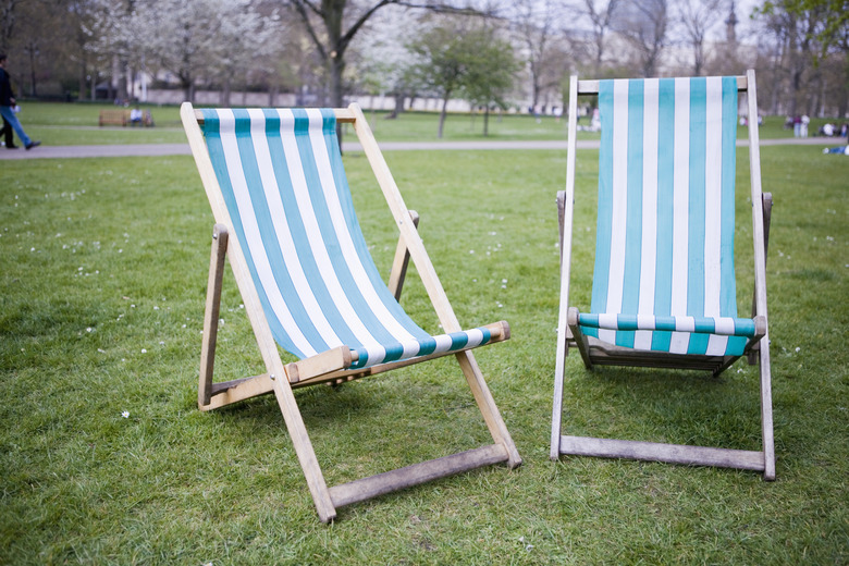 Traditional wood-framed deck chairs with vinyl seat in urban park