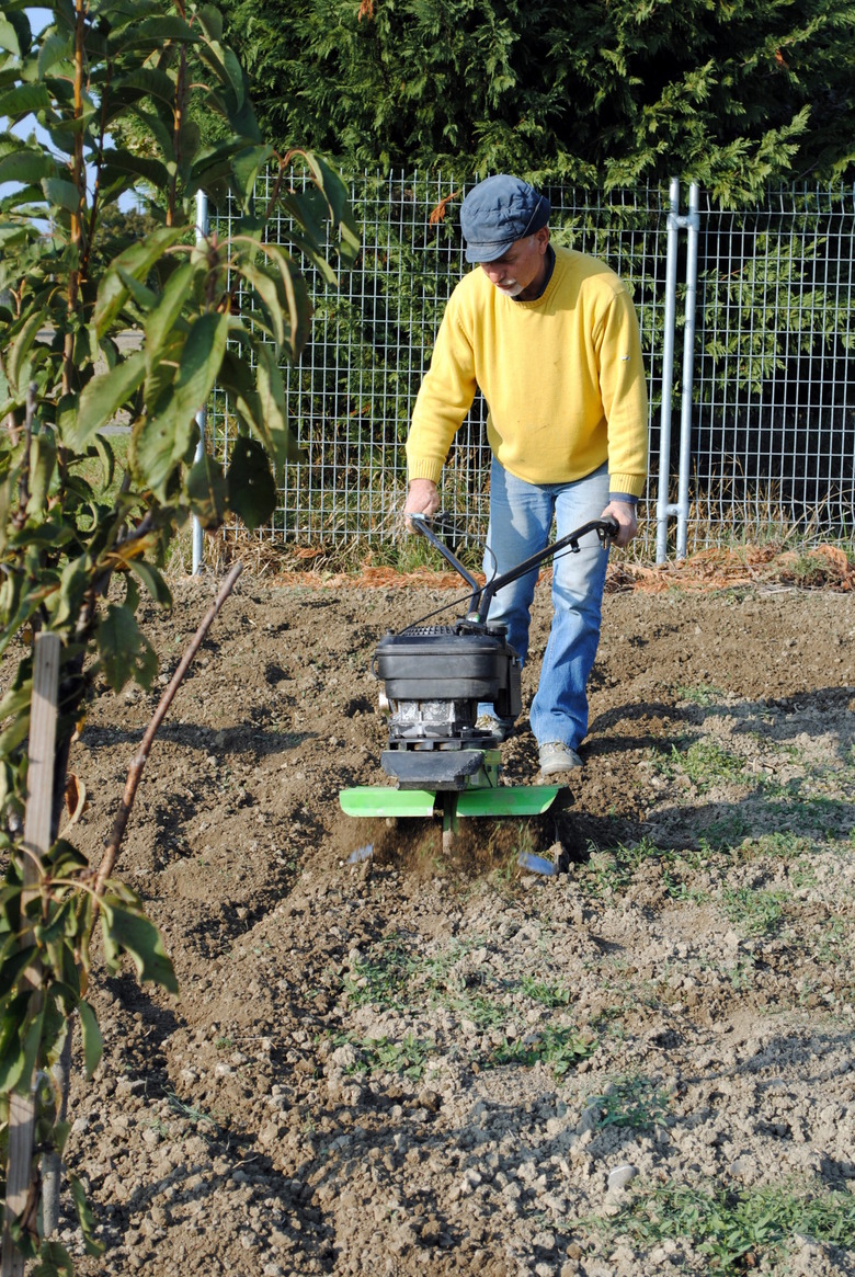 Middle age man with a rototiller