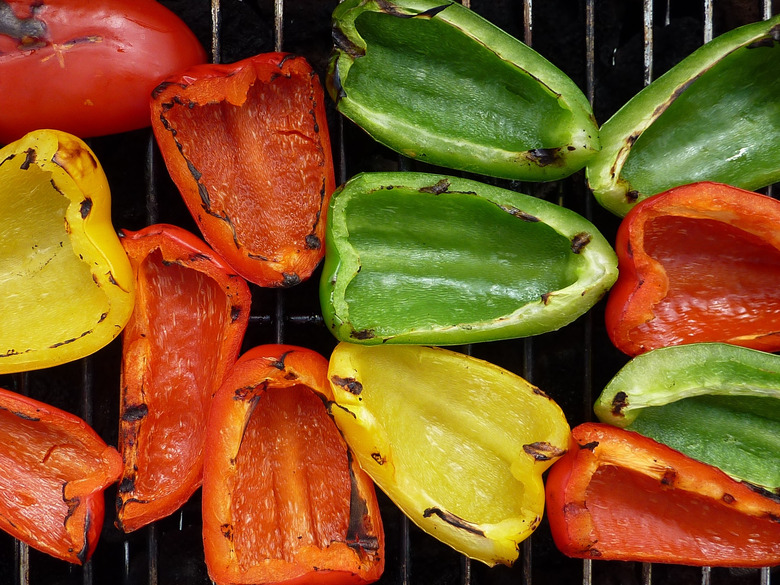 High angle view of colorful bell peppers on a grill.