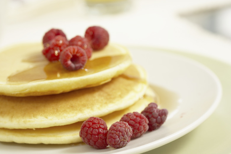 Raspberries on plate of pancakes