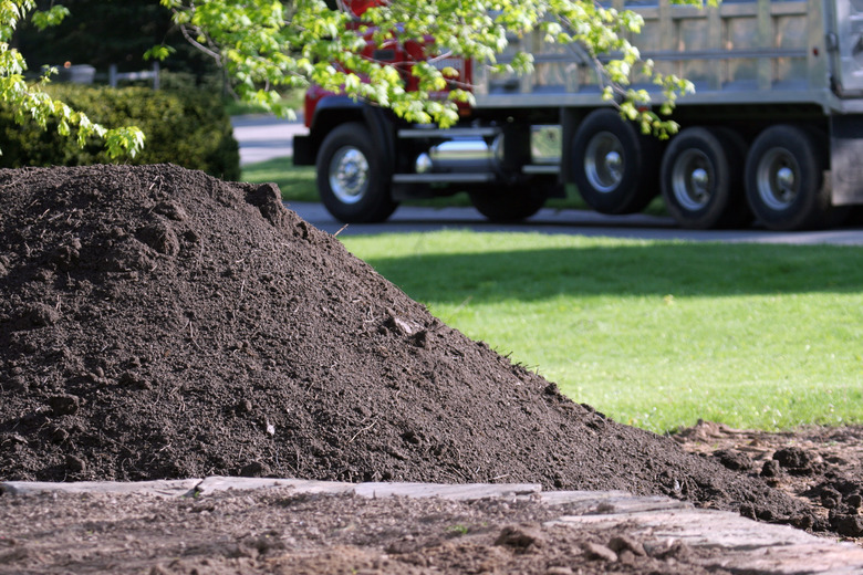 Topsoil delivery dump truck for residential landscaping