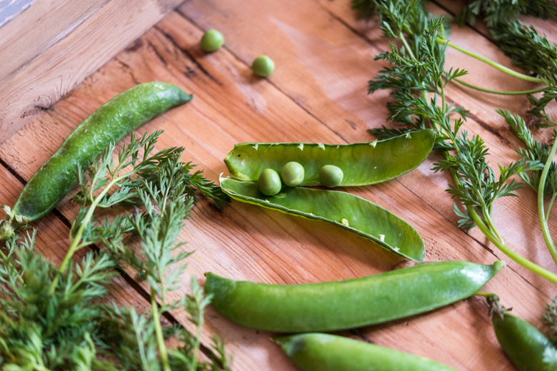 green snow peas in wooden box