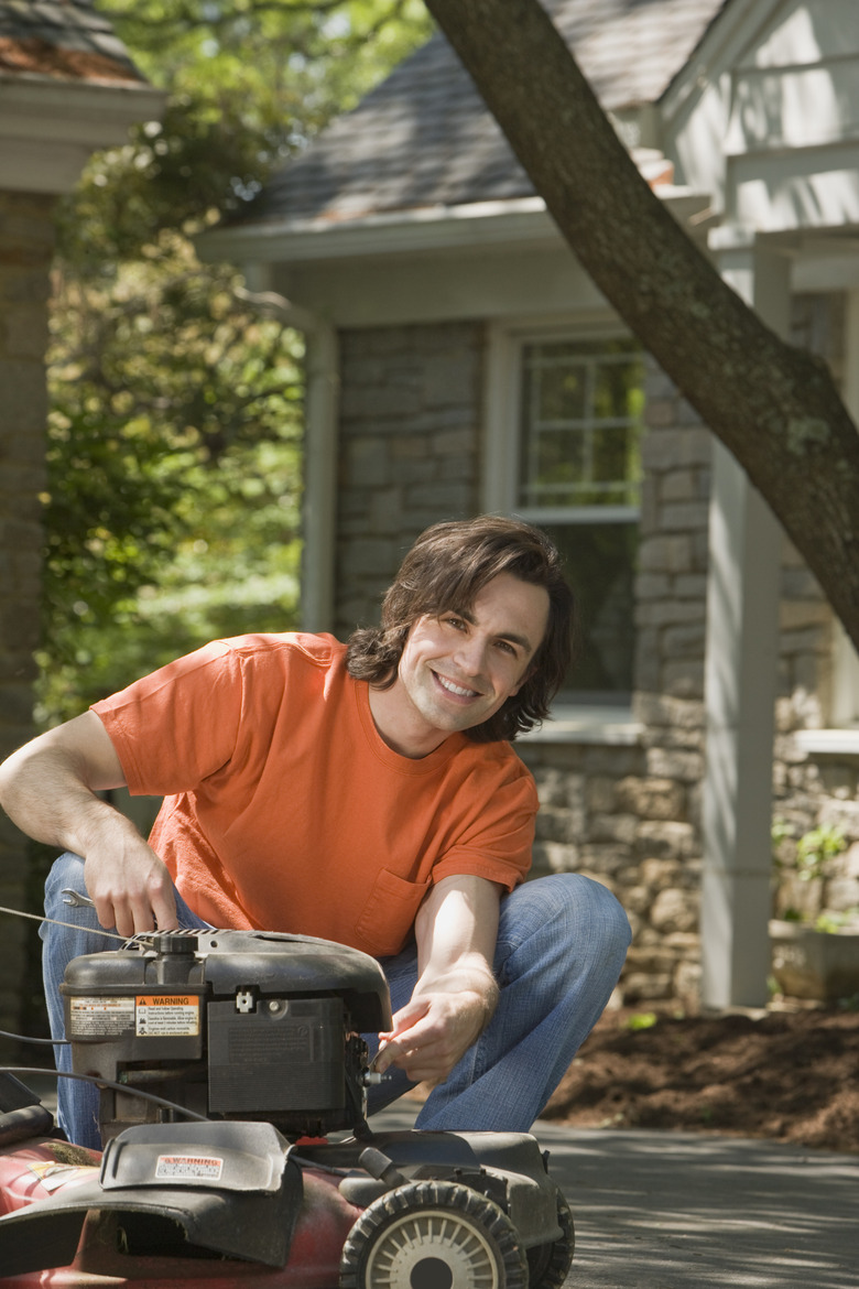 Smiling man with lawn mower