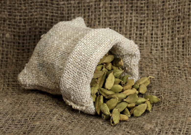 Green cardamom in sack on canvas background