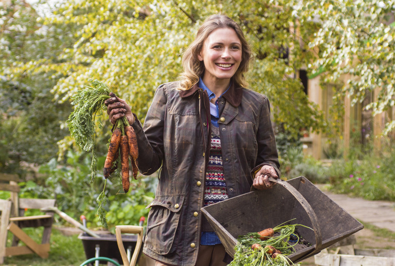 Beautiful woman with a bunch of carrots