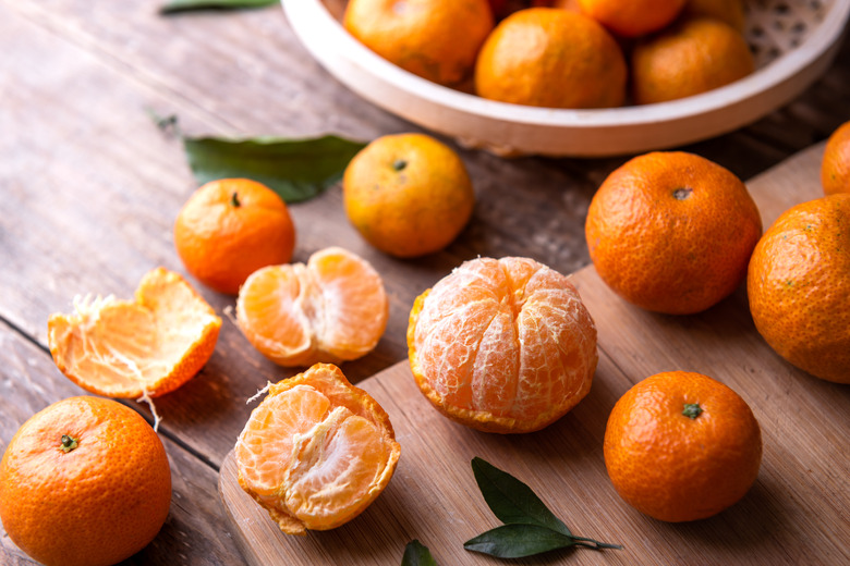 Fresh mandarin oranges on a wooden table.