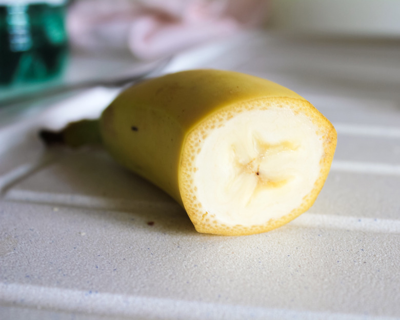 A close-up of a common banana on a table.