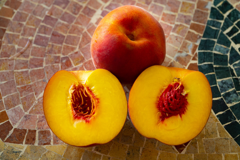 Close up of fresh nectarines on a stone table