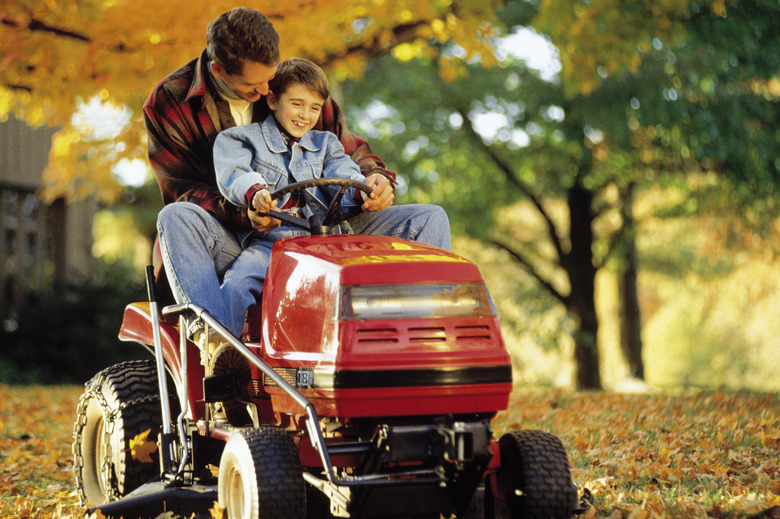 Father and son on riding mower